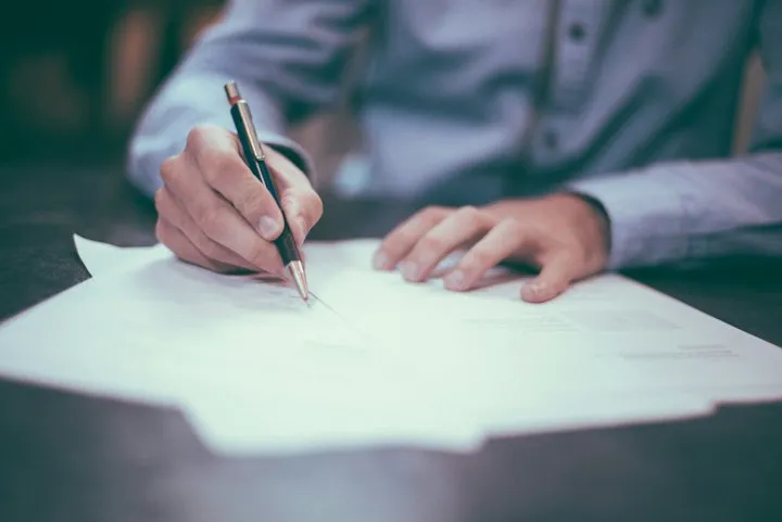 Person signing a policy document